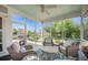 Relaxing screened-in porch with comfortable wicker furniture, a ceiling fan, and a serene outdoor view at 246 Calm Water Way, Summerville, SC 29486
