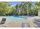 Community pool area with lounge chairs and green trees at 302 Elm Hall Cir, Summerville, SC 29483