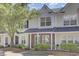 Charming townhome featuring a well-maintained yard, brick facade, and a welcoming entryway at 302 Elm Hall Cir, Summerville, SC 29483