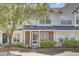 Inviting townhome with brick accents, manicured landscaping, and a covered entryway at 302 Elm Hall Cir, Summerville, SC 29483