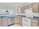 Well-lit kitchen boasts stainless steel appliances, neutral-tone cabinets, and ceramic tile flooring at 302 Elm Hall Cir, Summerville, SC 29483