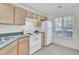 Bright kitchen features white appliances, light wood cabinets, and window for natural light at 302 Elm Hall Cir, Summerville, SC 29483