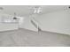 Open-concept living area with stairs, neutral carpet, and a view into other rooms at 302 Elm Hall Cir, Summerville, SC 29483