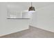Bright, carpeted room with a breakfast bar area, open to kitchen, and a modern light fixture at 302 Elm Hall Cir, Summerville, SC 29483