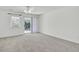 A naturally lit living room with neutral carpet and sliding glass doors to the yard at 302 Elm Hall Cir, Summerville, SC 29483