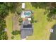 Aerial shot showcasing a home with a pool, outbuilding, lush lawn, private pond with dock, and wooded boundary at 3113 Edenvale Rd, Johns Island, SC 29455