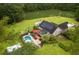Aerial view of the home with a pool, pond, pergola, solar panels, and ample green space at 3113 Edenvale Rd, Johns Island, SC 29455
