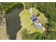 Spectacular aerial view of a home featuring a pool and pond surrounded by a lush forest at 3113 Edenvale Rd, Johns Island, SC 29455