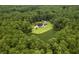 An aerial view of the house in the woods, nestled on a large lot and serene pond at 3113 Edenvale Rd, Johns Island, SC 29455