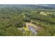 Expansive aerial view showcasing a pond, swimming pool, and lush greenery surrounding the charming home at 3113 Edenvale Rd, Johns Island, SC 29455