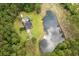 Magnificent aerial view showcasing a home with a pool and pond enveloped by a dense forest at 3113 Edenvale Rd, Johns Island, SC 29455