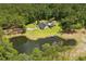 Beautiful home with a private pond and dock, surrounded by lush greenery and a sparkling swimming pool at 3113 Edenvale Rd, Johns Island, SC 29455