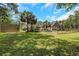 Large backyard with a fenced garden, palm trees, shed, and view of the home's exterior at 3113 Edenvale Rd, Johns Island, SC 29455
