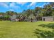 Spacious backyard featuring a private pool, palm trees, green lawn, and outbuilding at 3113 Edenvale Rd, Johns Island, SC 29455