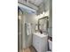 Well-lit bathroom with a framed mirror, modern vanity, shower and beadboard walls at 3113 Edenvale Rd, Johns Island, SC 29455