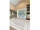 Bathroom with a jetted tub, white tile, and stylish shelving offering lots of storage at 3113 Edenvale Rd, Johns Island, SC 29455