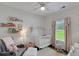 Charming Bedroom featuring a white crib, cozy rocking chair, and lovely floral decorations at 3113 Edenvale Rd, Johns Island, SC 29455