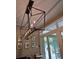 Elegant chandelier with candlelight bulbs and a view of the outdoor play area through sliding glass doors at 3113 Edenvale Rd, Johns Island, SC 29455