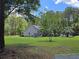 Spacious backyard with solar panels, trampoline, fenced pool, and mature trees offering plenty of space for outdoor activities at 3113 Edenvale Rd, Johns Island, SC 29455