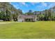 Charming home with a two-car garage, manicured lawn, and an American flag proudly displayed at 3113 Edenvale Rd, Johns Island, SC 29455