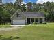 Charming home with landscaped front yard, attached garage and a welcoming front porch at 3113 Edenvale Rd, Johns Island, SC 29455