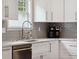 Kitchen featuring white cabinets, gray backsplash, stainless steel appliances, and modern fixtures at 3113 Edenvale Rd, Johns Island, SC 29455