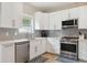 Well-lit kitchen with white cabinets, stainless steel appliances, stylish backsplash, and ample storage at 3113 Edenvale Rd, Johns Island, SC 29455