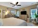 Bright main bedroom boasting a ceiling fan, two dressers, and lots of natural light from dual windows at 3113 Edenvale Rd, Johns Island, SC 29455