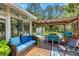 Cozy outdoor living space with comfortable seating, a dining area, and view of the backyard at 3113 Edenvale Rd, Johns Island, SC 29455