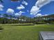 A serene pond with a small dock, surrounded by lush greenery and mature trees, enhances the property's charm at 3113 Edenvale Rd, Johns Island, SC 29455