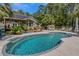 Inviting pool area with a lounge chair, pergola, and lush landscaping at 3113 Edenvale Rd, Johns Island, SC 29455