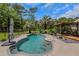 Refreshing pool with seating areas, lush tropical landscaping, and a covered pergola at 3113 Edenvale Rd, Johns Island, SC 29455