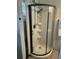 Bathroom corner shower with white subway tile, shelving, and black hardware at 3113 Edenvale Rd, Johns Island, SC 29455