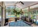 Bright sunroom with large windows, ceiling fan, stylish rug, and a view of the outdoor swimming pool at 3113 Edenvale Rd, Johns Island, SC 29455