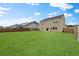 Large backyard with green lawn, wooden fence and the exterior of a two story home at 320 Blue Shadows Ct, Summerville, SC 29486