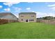 A sprawling green backyard with a two-story home, enclosed by a sturdy wooden fence at 320 Blue Shadows Ct, Summerville, SC 29486