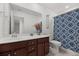 Well-lit bathroom featuring dark wood cabinets, an extended countertop, and patterned shower curtains at 320 Blue Shadows Ct, Summerville, SC 29486