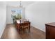 Bright dining room with wood floors, table, chairs, and natural light from windows at 320 Blue Shadows Ct, Summerville, SC 29486
