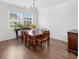 Sunlit dining room with wood floors, table, chairs, and large windows at 320 Blue Shadows Ct, Summerville, SC 29486