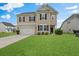 Charming two-story home with a well-manicured lawn and attached two-car garage at 320 Blue Shadows Ct, Summerville, SC 29486