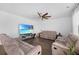 Spacious living room features plush seating, a ceiling fan, and a large screen television for entertainment at 320 Blue Shadows Ct, Summerville, SC 29486