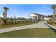 Community pool area showcasing the pool house, palm trees, and inviting space at 320 Blue Shadows Ct, Summerville, SC 29486