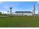 Beautiful community pool area with a covered pavilion, palm trees, and well-manicured landscaping at 320 Blue Shadows Ct, Summerville, SC 29486