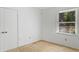 Bright bedroom with natural light features clean walls, neutral carpet, and ample closet space at 3249 Stonehaven Dr, North Charleston, SC 29420