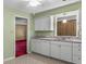 Well-lit kitchen features white cabinetry, neutral countertops, and an open view to the Gathering room at 3249 Stonehaven Dr, North Charleston, SC 29420