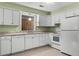 Bright kitchen boasts white appliances, neutral countertops, and ample cabinet space at 3249 Stonehaven Dr, North Charleston, SC 29420