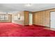 Expansive room boasts wood paneling, vibrant carpet, and a layout perfect for entertaining at 3249 Stonehaven Dr, North Charleston, SC 29420