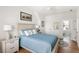 Comfortable bedroom with light blue bedding, wood floors, and ensuite bathroom at 3305 Knot Aly, Johns Island, SC 29455