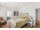 Cozy bedroom featuring a light yellow quilt, wood floors, and sitting area at 3305 Knot Aly, Johns Island, SC 29455