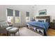 Cozy bedroom with a comfortable chair, soft blue accents, and natural light from a private balcony at 3305 Knot Aly, Johns Island, SC 29455